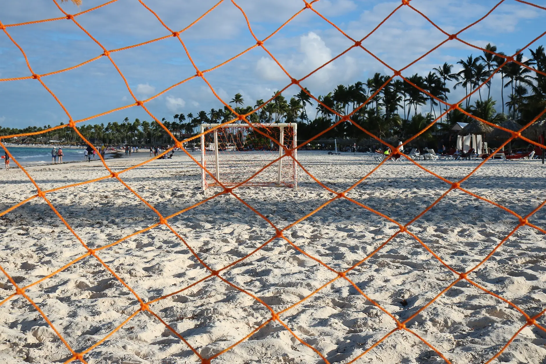 Playa de Punta Cana con cocoteros inclinados sobre la arena blanca